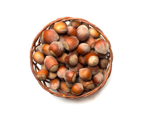 Hazelnuts in basket isolated on white background, top view