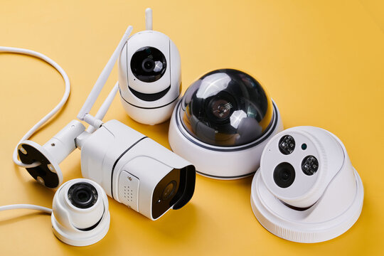 Surveillance cameras, set of different videcam, cctv cameras isolated on yellow background close up. home security system concept