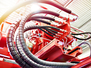 Hydraulic hoses on mining industrial machine