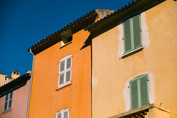 Fototapeta na wymiar colourful buildings fro, the south of France with a blue sky in the background