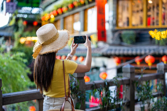 Tourist woman use cellphone to take photo in Jiufen village