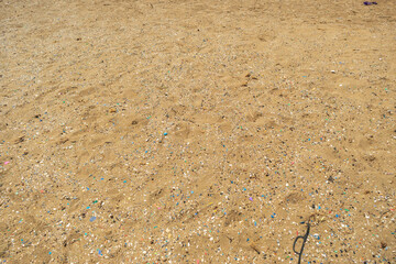 Fototapeta na wymiar Microplastics on Sand Beach