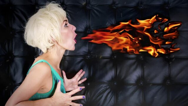 Cinemagraph of blond woman spitting fire
