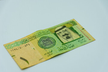 Saudi Arabia riyal banknote on a white background. Selective focus.