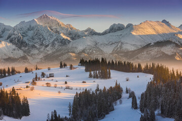 Tatra Mountains, winter, snow, frost. Panorama of the winter Tatra Mountains and peaks at sunset,...
