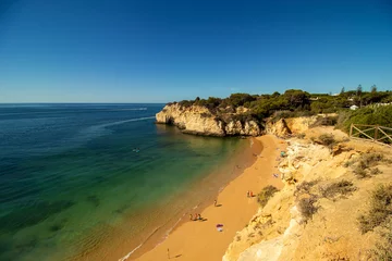 Photo sur Plexiglas Plage de Marinha, Algarve, Portugal Beach with crystal blue waters in the village of Armação de Perâ, Algarve, Portugal