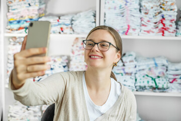 Female owner of an independent online baby clothing store. Small business. Workplace.