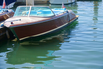 vintage wood motorboat docked in the harbor