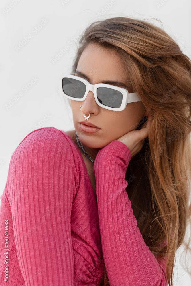 Wall mural stylish fresh portrait of a beautiful young redheaded woman model with cool fashion white glasses wi