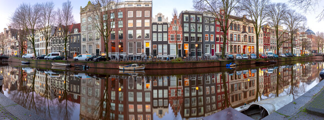 Panorama of the city waterfront of Amsterdam at sunset.