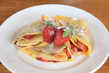 dessert, sandwich with strawberries and powdered sugar, on a white plate