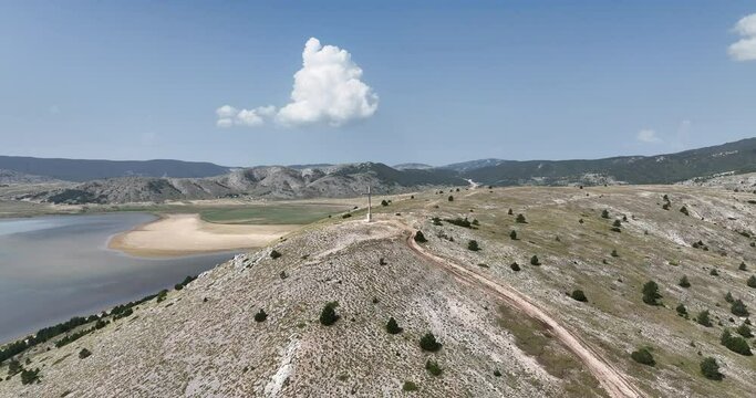 stian Religio Cross Situated On Top Of Mountain Under Blue Sky. Aerial orbiting shoot.