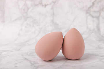 Beauty blender on a marble background.Sponge for makeup cosmetics. Makeup products. Beauty concept. Place for text. Space for copy. Flat lay
