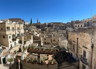 Obraz premium View on the Sassi di Matera, located in Basilicata, Italy. They represent the historic center of the city and are a World Heritage Site. They are rupestrian architectures carved into the rock.