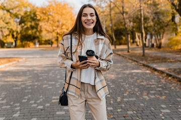 attractive young woman walking in autumn wearing jacket