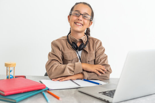 Online Education. Cute little Girl Study At Home With Laptop And Wireless Headphones, Adorable Kid Having Web Lesson With Teacher, Enjoying Distance Learning During Quarantine Time, Free Space