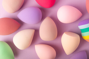 Beauty blender on a lilac background.Sponge for makeup cosmetics. Makeup products. Beauty concept. Place for text. Space for copy. Flat lay