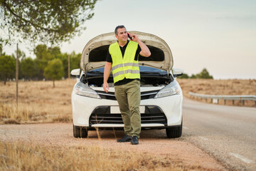 a man talking to the car insurance company to ask for travel assistance for a car breakdown
