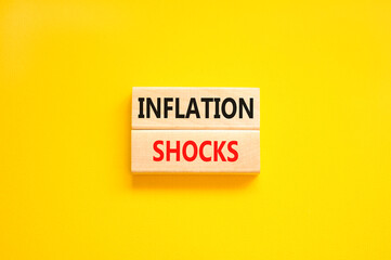 Inflation shocks symbol. Concept words Inflation shocks on wooden blocks. Beautiful yellow table yellow background. Business inflation shocks concept. Copy space.