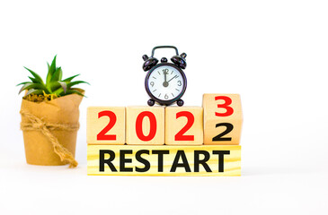2023 restart new year symbol. Turned wooden cube and changes words Restart 2022 to Restart 2023....