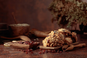 Oatmeal raisin cookies on a brown table.