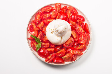 Burrata cheese salad with cherry tomatoes, olive oil and seasoning. Fresh food concept. 