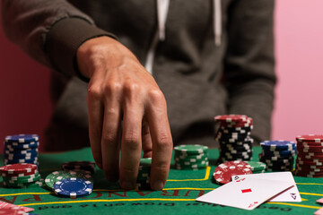 Fototapeta na wymiar man playing blackjack at the table and betting chips