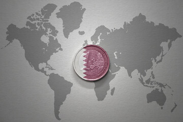 euro coin with national flag of qatar on the gray world map background.3d illustration.