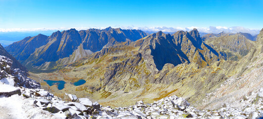 Mountain panorama.  Mountain rocky landscape. Panoramic photo of mountain peaks and valleys. Majestic view of the rock peaks. High-resolution picture. Real photo of Tatra Mountains in Slovakia.