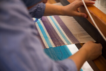Carpet weaving using traditional techniques on a loom. , close-up of weaving and handmade carpet production.