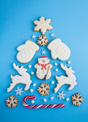 Christmas tree from gingerbread on the blue background. Copy space. Top view.