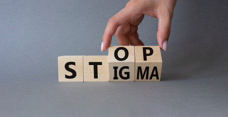 Stop and Stigma symbol. Concept words Stop and Stigma on wooden cubes. Beautiful grey background....