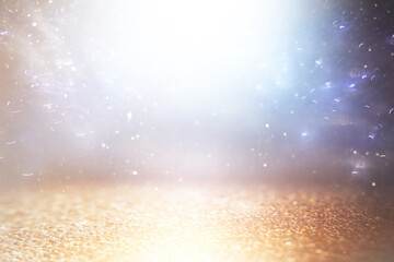 background of abstract gold, blue and silver glitter lights. defocused