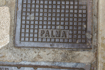 Metal street manhole cover in Palma de Mallorca, Spain