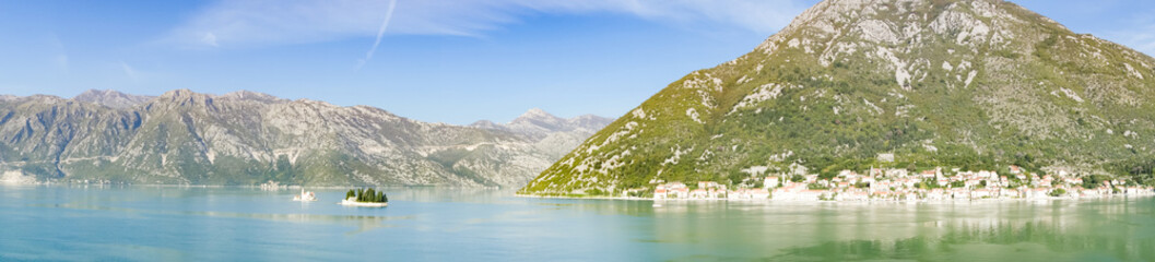 Fototapeta na wymiar Panoramic view of Bay of Kotor from the sea surrounded by mountains in Montenegro, one of the most beautiful bay in the world