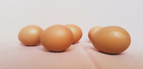 Some eggs are laid on a pink cloth.