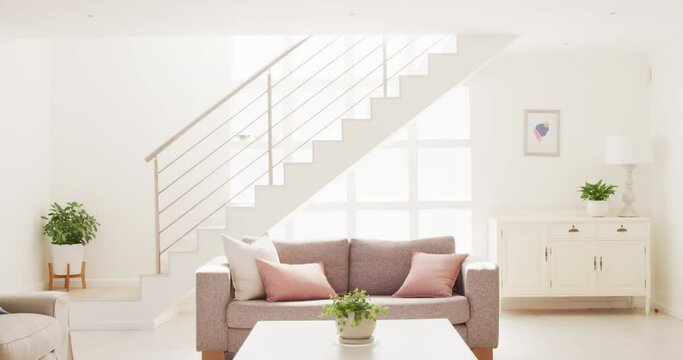 General view of living room interior with sofa and stairs
