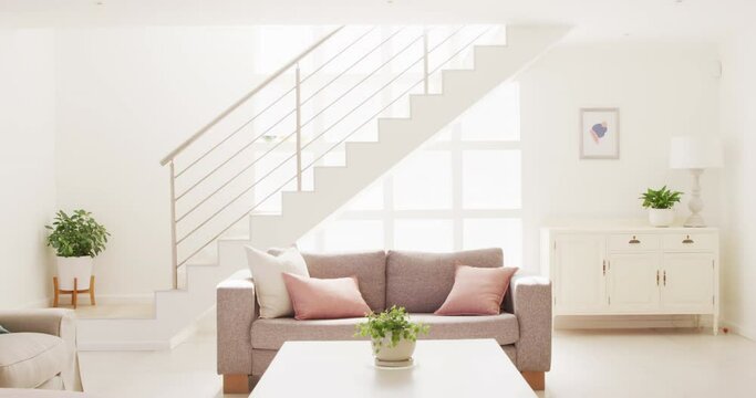 General view of living room interior with sofa and stairs