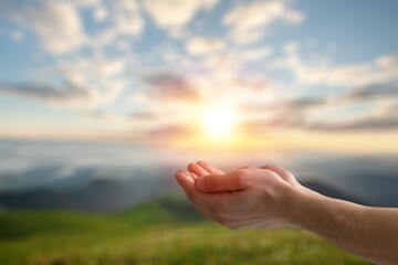 Christian person hands pray on nature background..