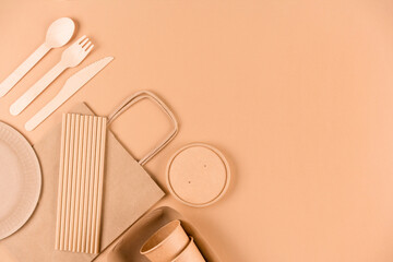 Ecology tableware - paper food packaging over light brown background with copy space. Street food...