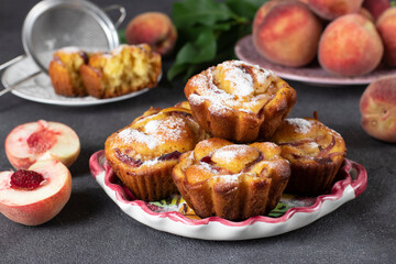Naklejka na ściany i meble Homemade tasty muffins with peaches on plate on gray background