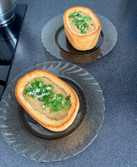 Cream of soup inside a rectangular bread of cauliflower and mushrooms with herbs.
