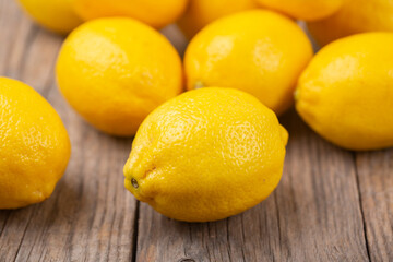 Fresh whole lemons on wooden rustic background
