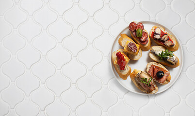 Set of Spanish pinchos with seafood and fish on bread