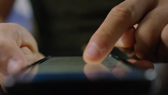 Close shot of finger scrolling through a touch screen smart phone