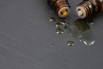 two dropper bottles with essential oil spilling and mixing oil drops