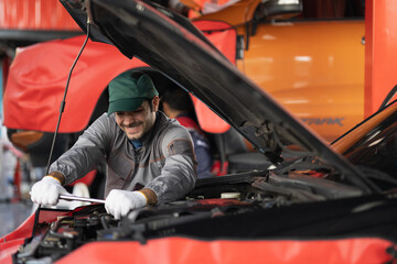 Automobile mechanic man checking car damage broken part condition. diagnostic and repairing vehicle at garage automotive, Concepts of car care check and fixed and services insurance.