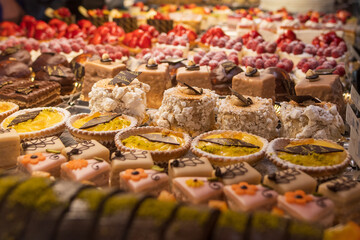 Assortment of delicious cakes, sweet treats and desserts in a cakeshop in the Blackforest region of Germany