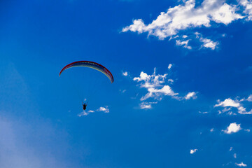 Paragliding against a beautiful blue sky. Active lifestyle, sports flights