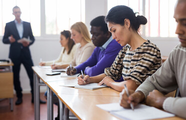 Fototapeta premium Woman in group of students in a university audience